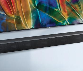 image of a tv with a soundbar underneath it. both the tv and the soundbar are mounted to a wall