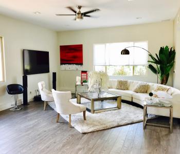 image of a living room with a tv to the left with surround sound speakers on either side of the tv