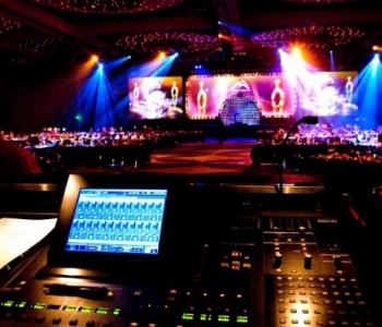 image of a computer managing lighting from above a lit stage inside of a theater