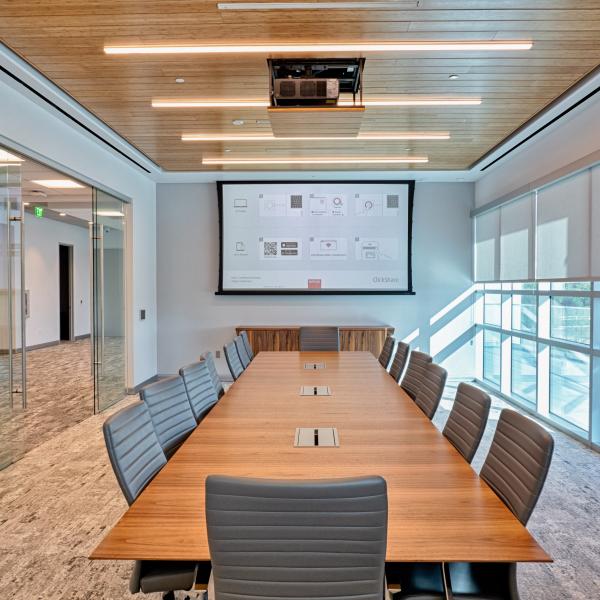 conference room with ceiling mounted projector and screen